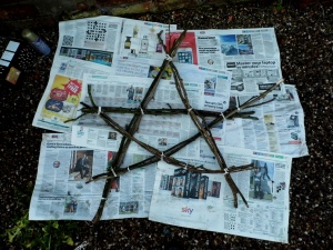 Arrange your stick bundles into a star shape and secure with string.