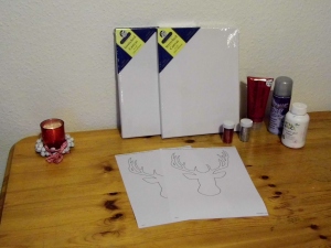 Firstly, prepare your workspace. You will need stretched canvas (or plain card if you don't have canvas), paint, glitter, glue, a stencil - I googled 'deer template' to find mine. You will also need a pencil, ruler or tape measure, string, nails, picture hooks, hammer and newspaper.
