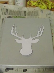 Cut out your stencil and place it onto your canvas. Trace around the stencil with a pencil.